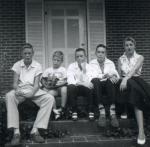 Inner-city kids lounging on porch steps, 1955.